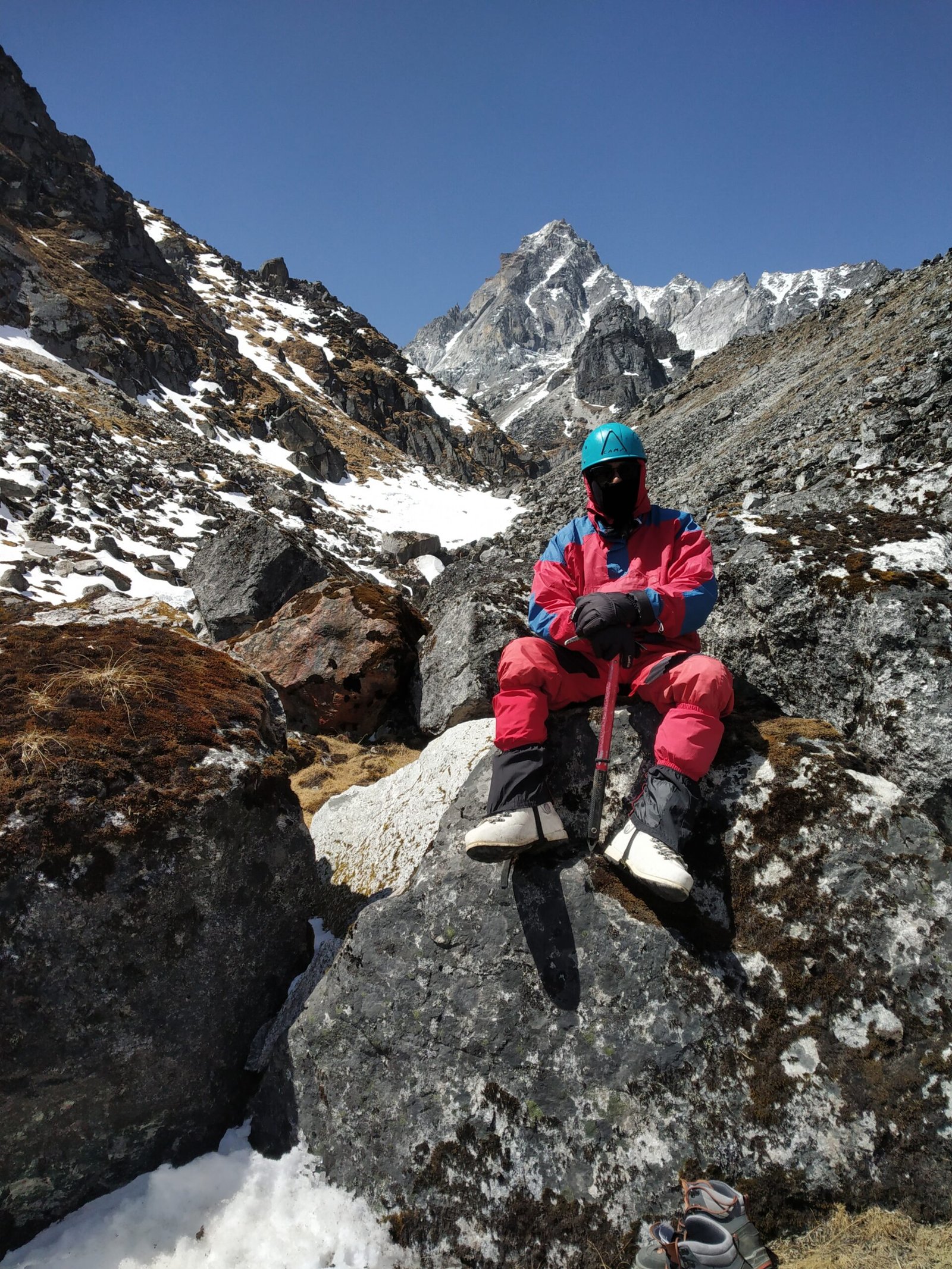 Roped team of mountaineers climbing an icy glacier slope during training