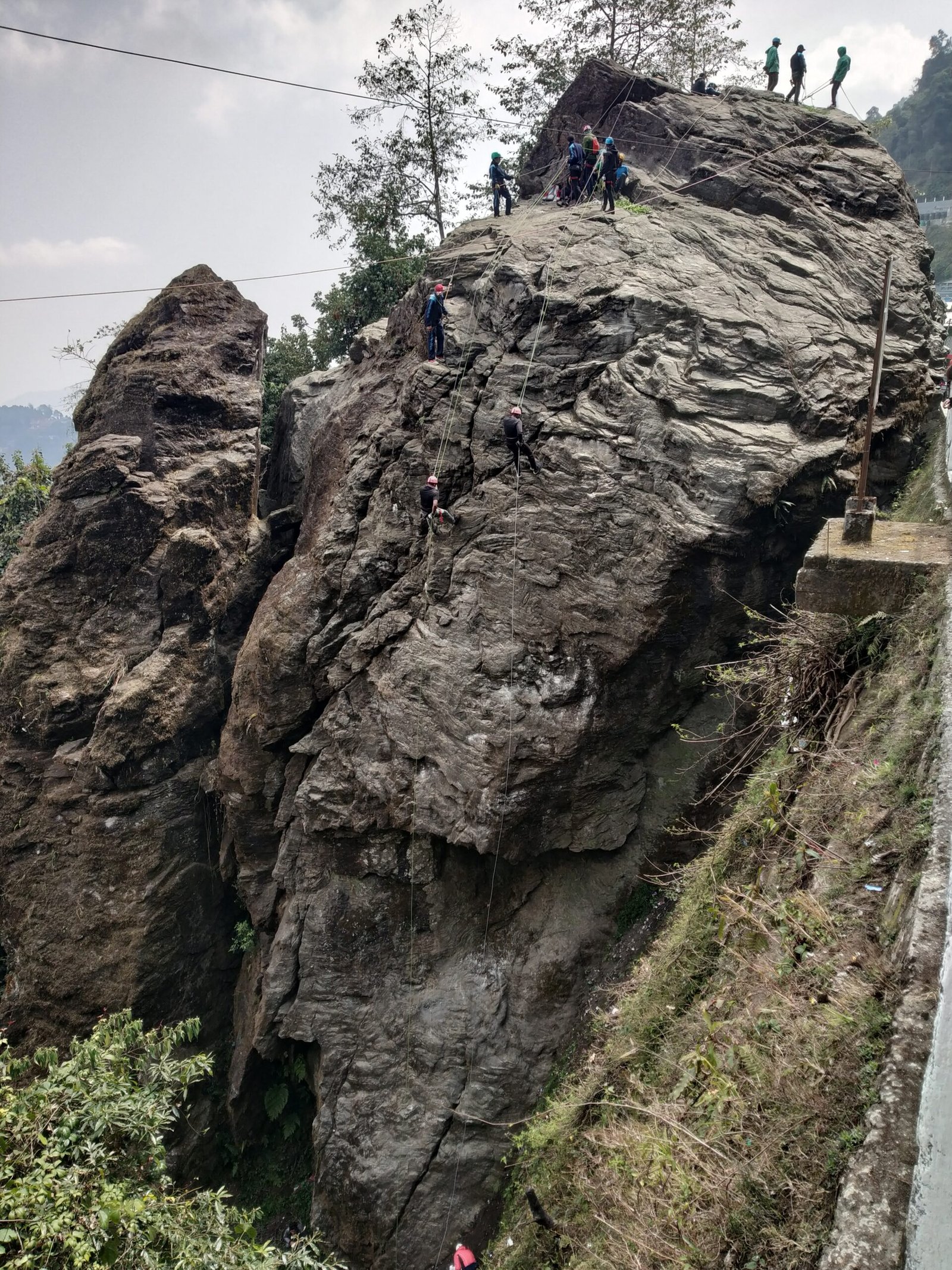 Trainees rappelling and rock climbing during HMI basic mountaineering course
